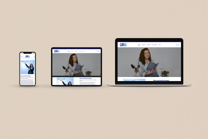 Imagen de un iphone, un ipad y una laptop con la web de Girl in Corporation en sus pantallas.